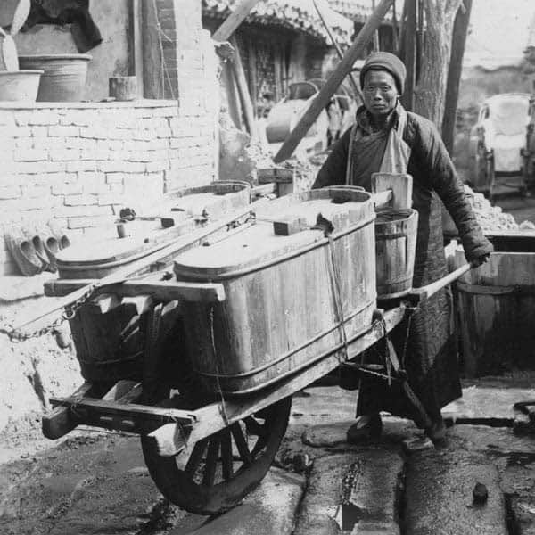 man_pushing_wooden_cart